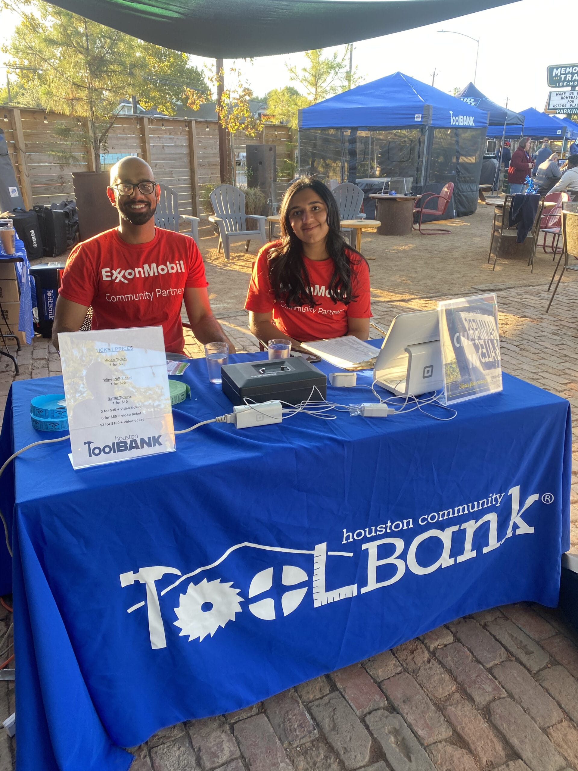 Houston ToolBank volunteers working at a table, handing out information