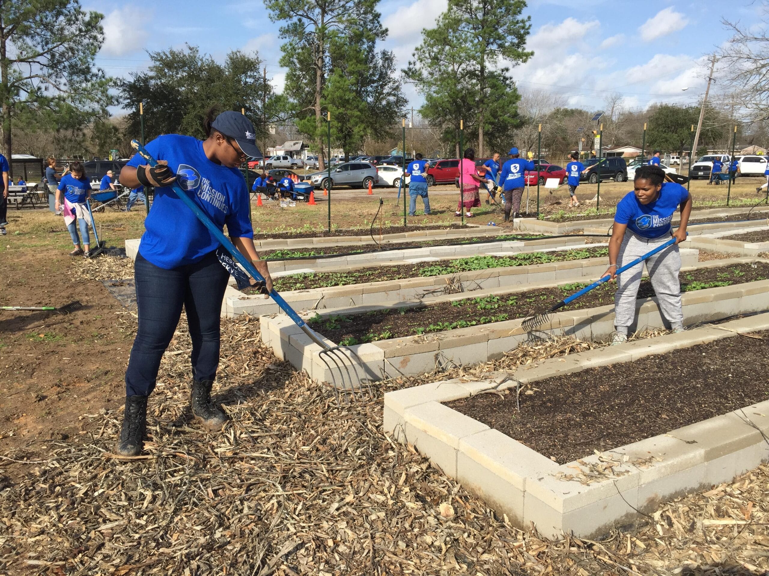 Houston ToolBank volunteers tilling soil at a community garden