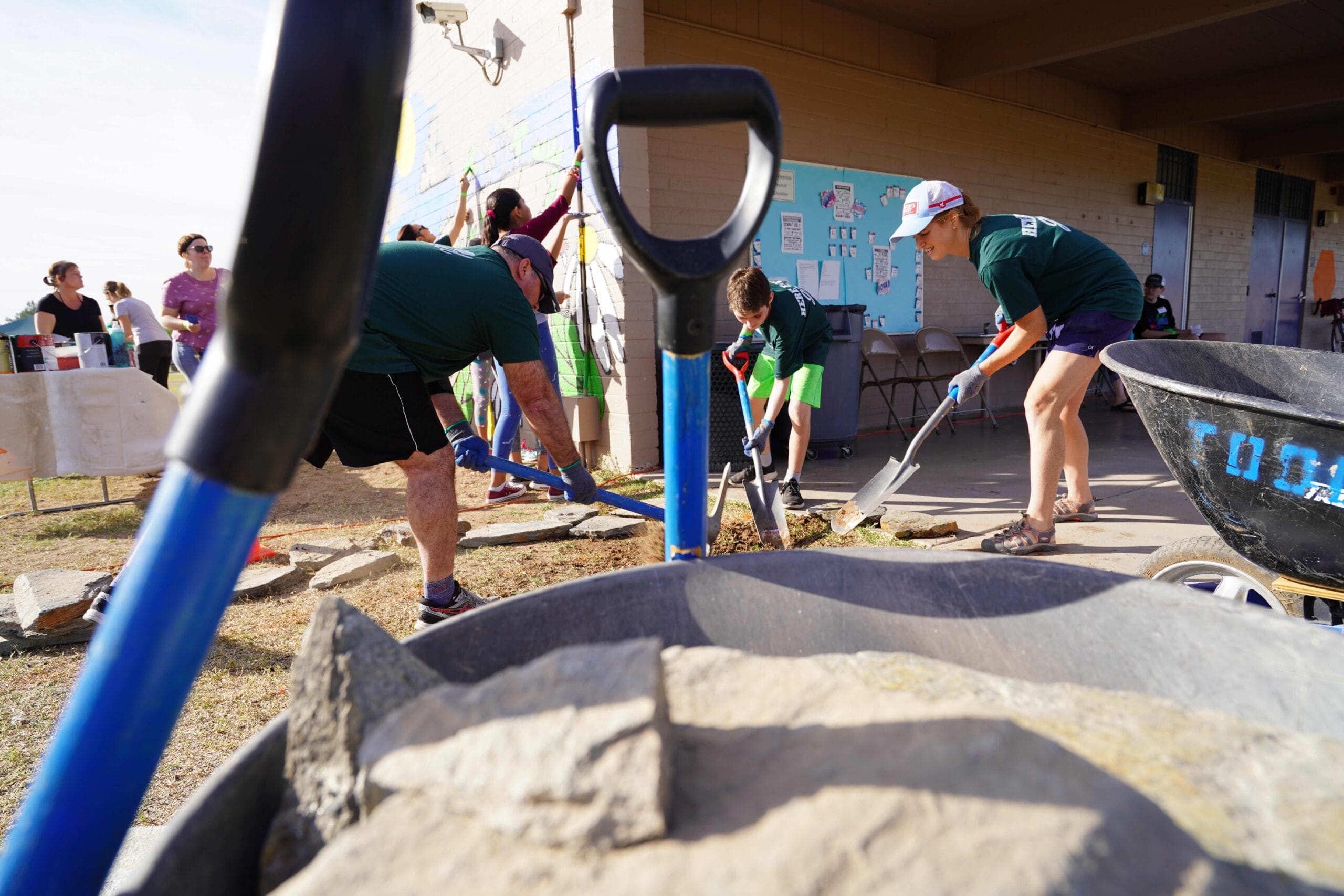 A group of volunteers shoveling dirt at a Houston ToolBank event