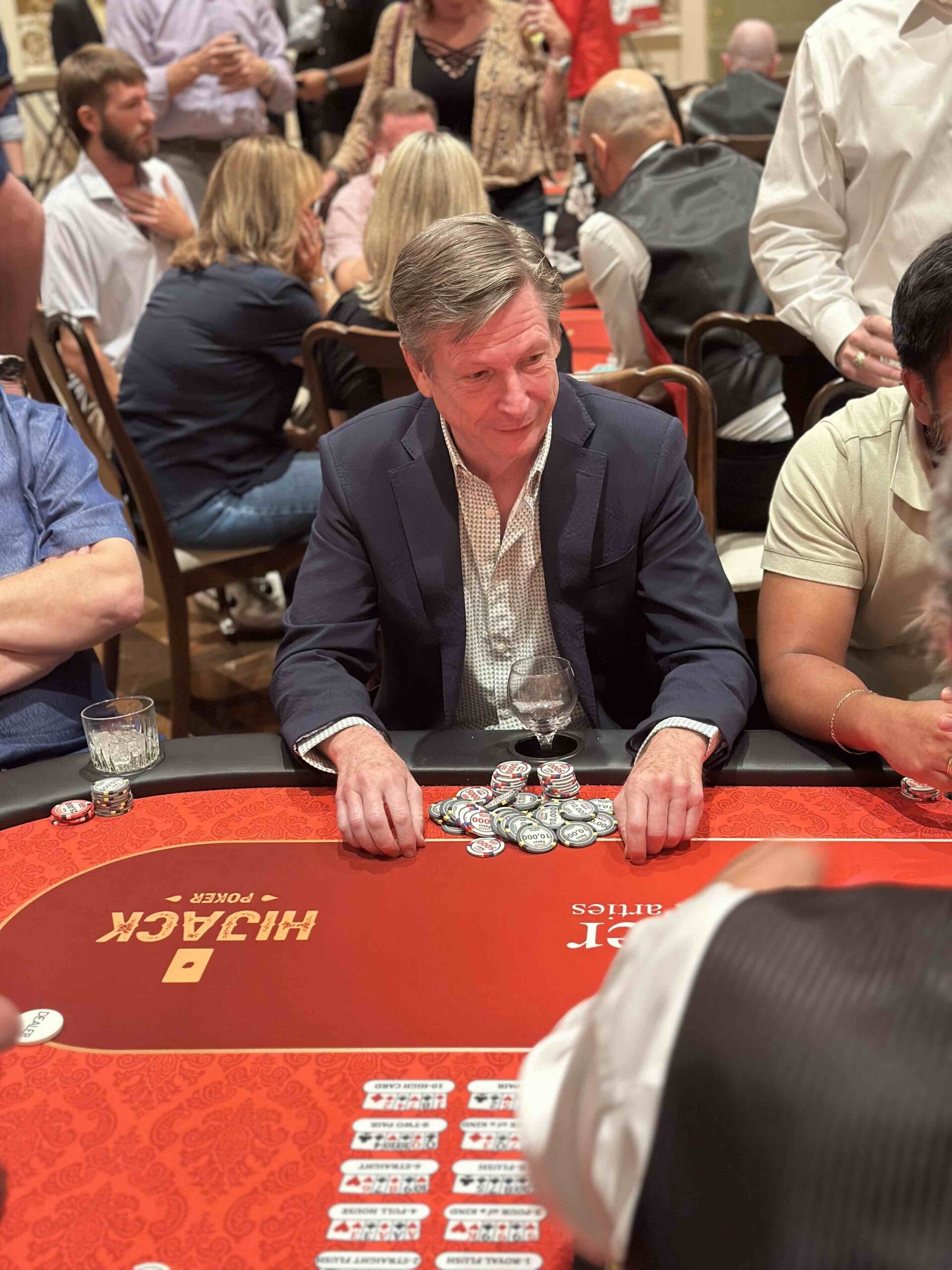 A HoustonTool Bank staff member looking at his poker chips at a blackjack table