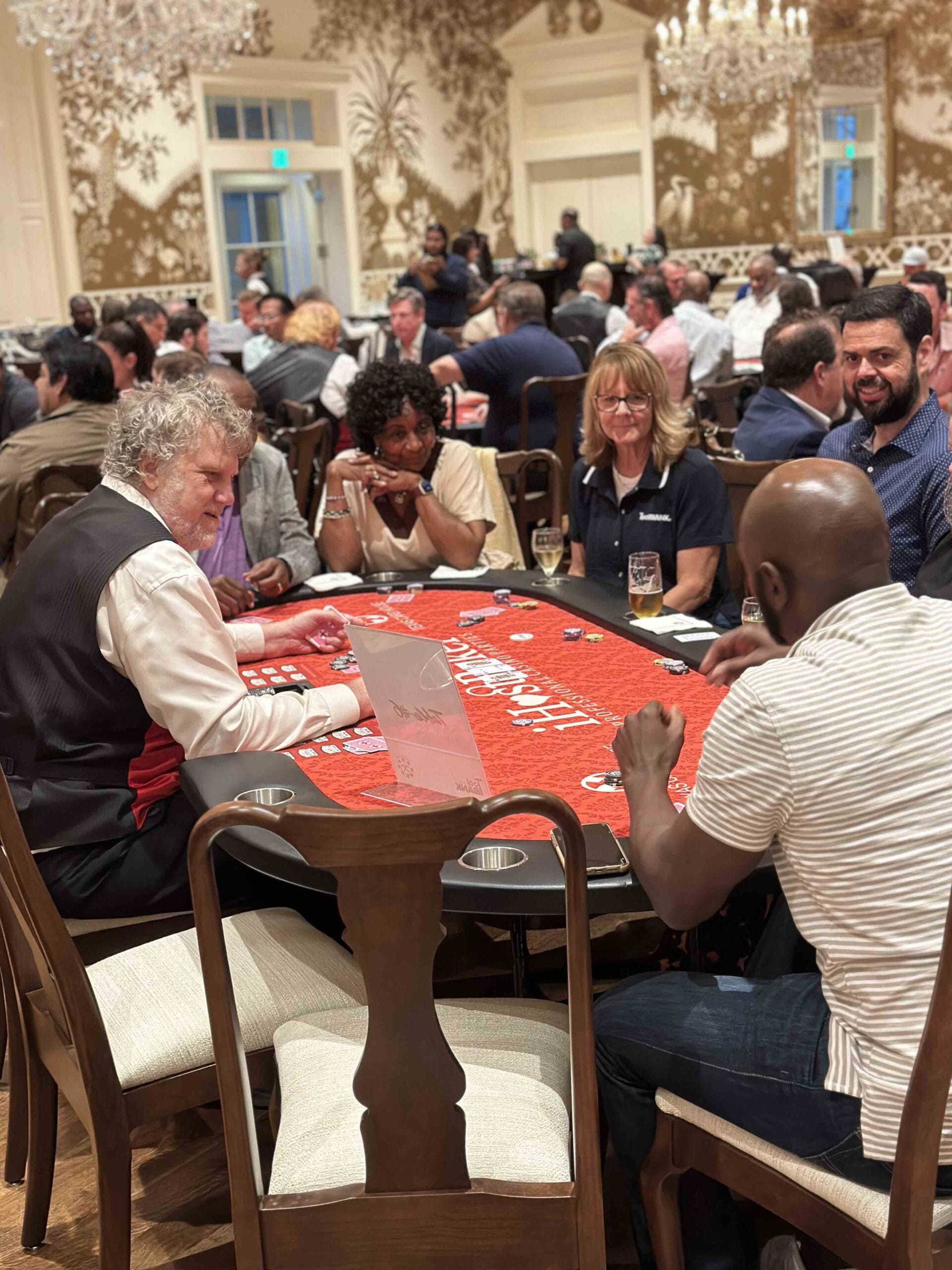 Houston ToolBank volunteers playing poker in a large hall for charity