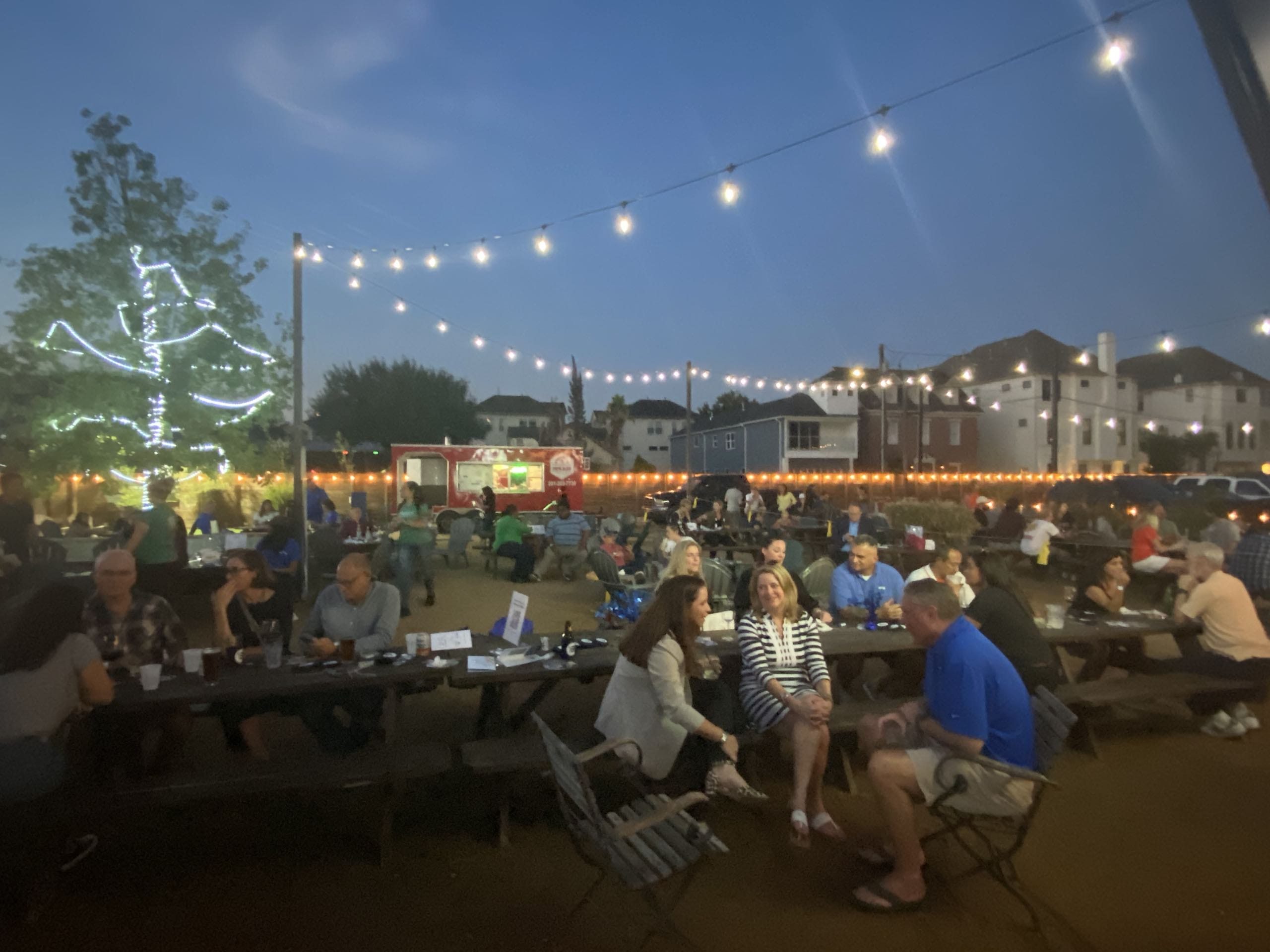 Houston ToolBank volunteers dining outside at a large Houston bar