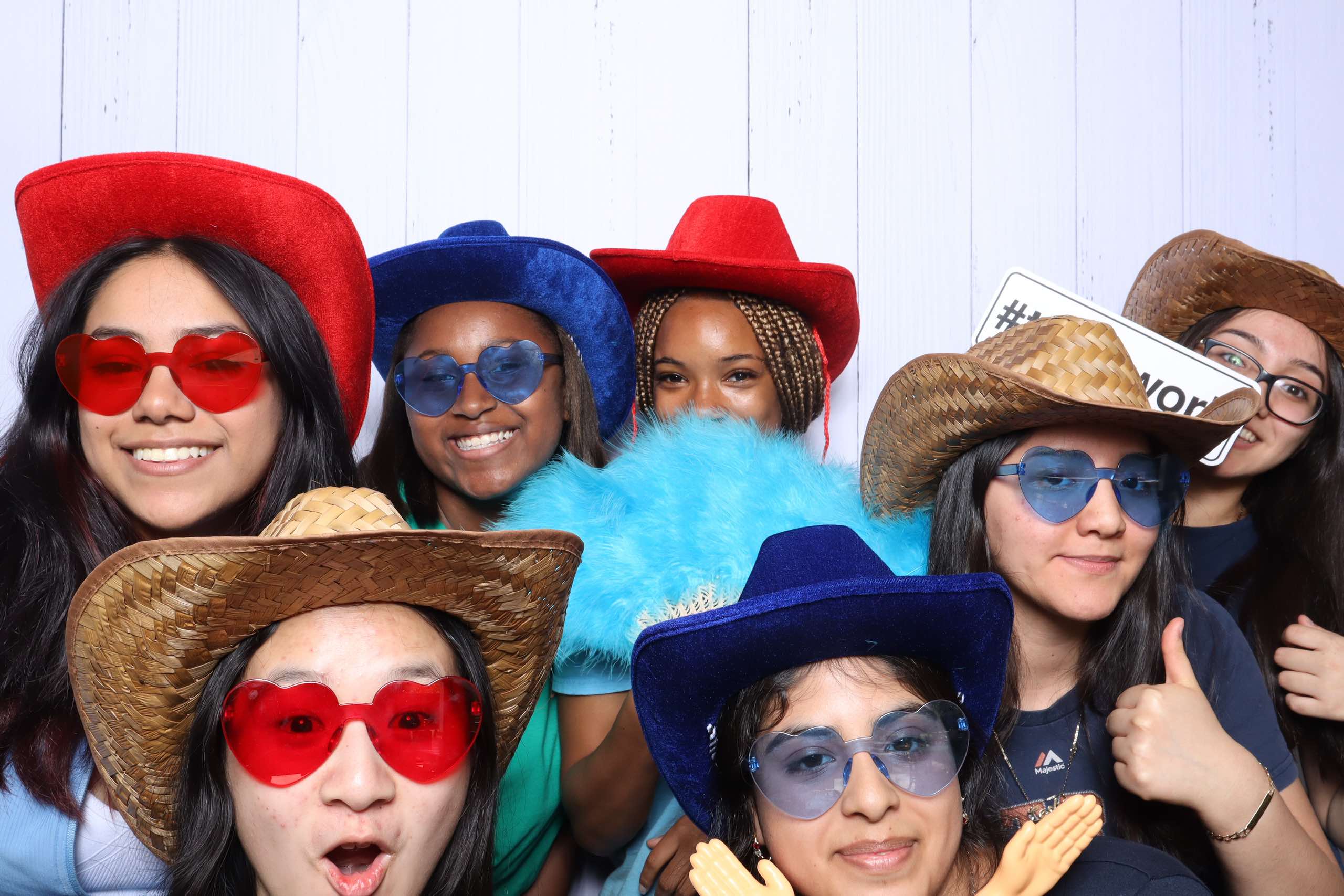 Teenage Houston Toolbank volunteers all wearing fun cowboy hats in a group pictures