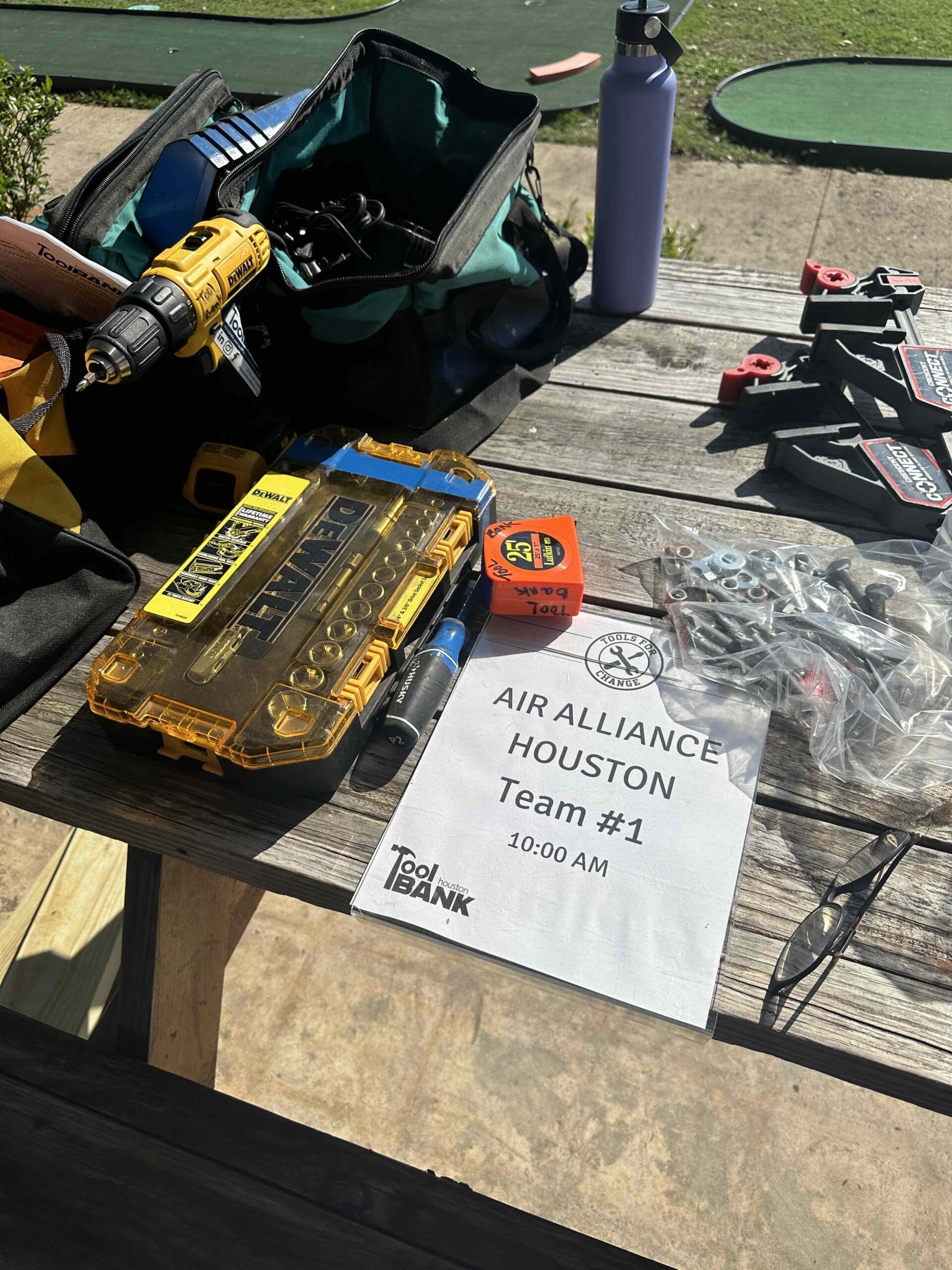 A table filled with tools for Air Alliance volunteers at a Houston ToolBank event