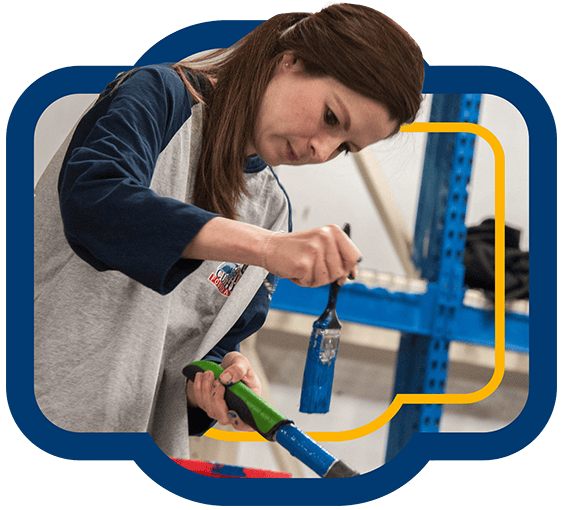 A blue badge showing a woman painting a tool handle blue