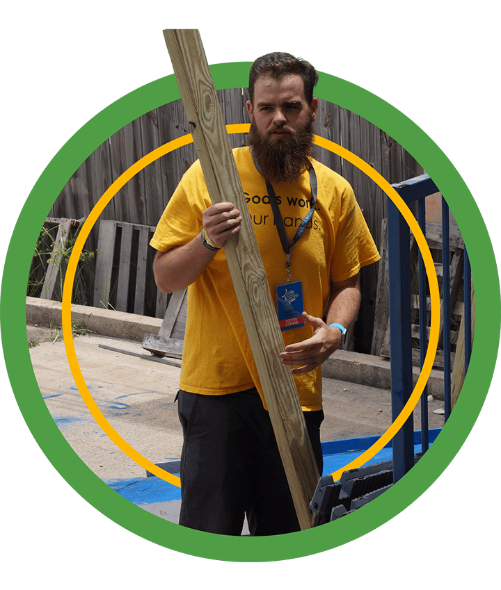 A green badge showing a Houston ToolBank volunteer holding up a plank of wood